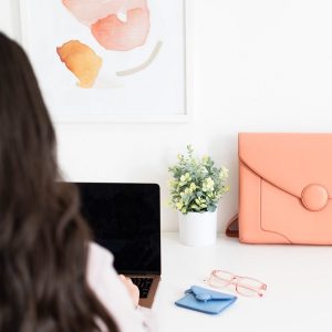 Woman working on laptop from back