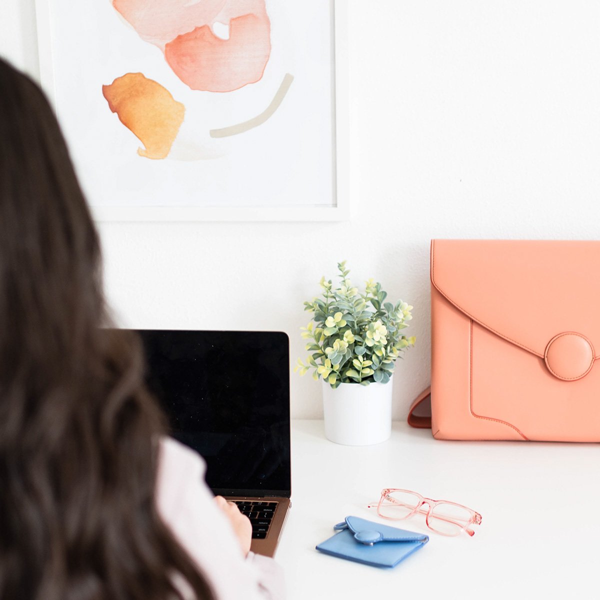 Woman working on laptop from back