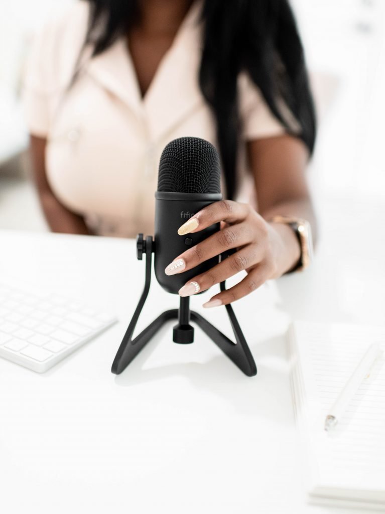 Women Torso holding desktop microphone