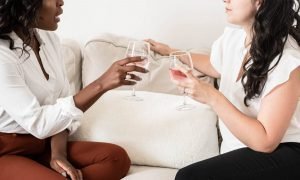 2 Women sitting on couch talking