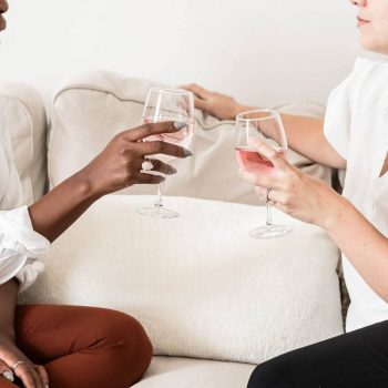 2 Women sitting on couch talking